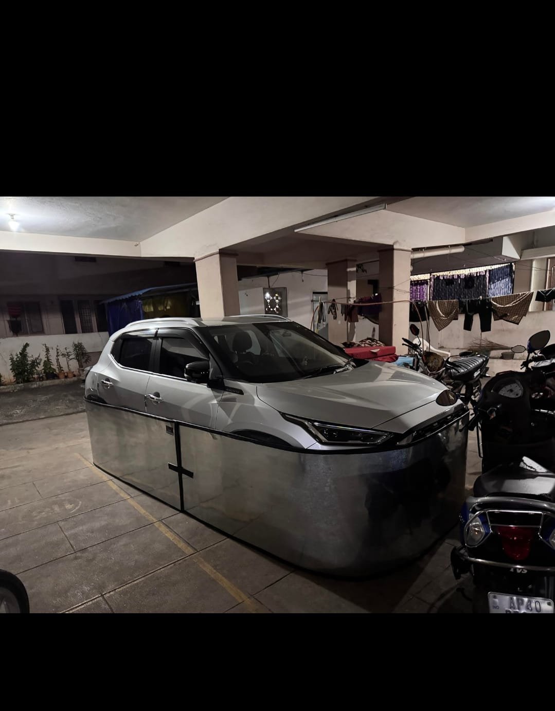 Car-lungi 360° anti-rodent steel skirt on parked car in residential parking