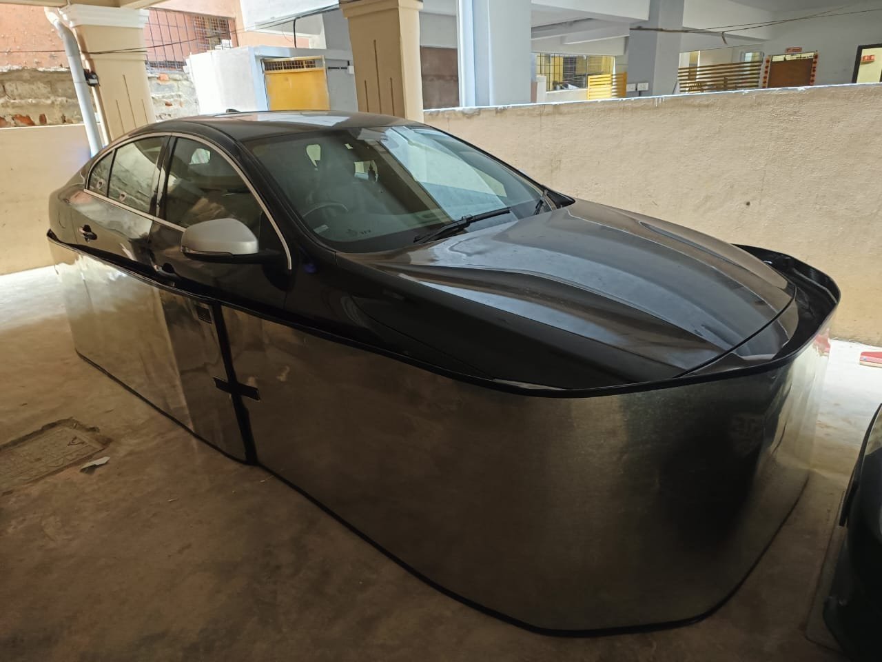 Car-lungi GI sheet rodent guard installed on car overnight protection India